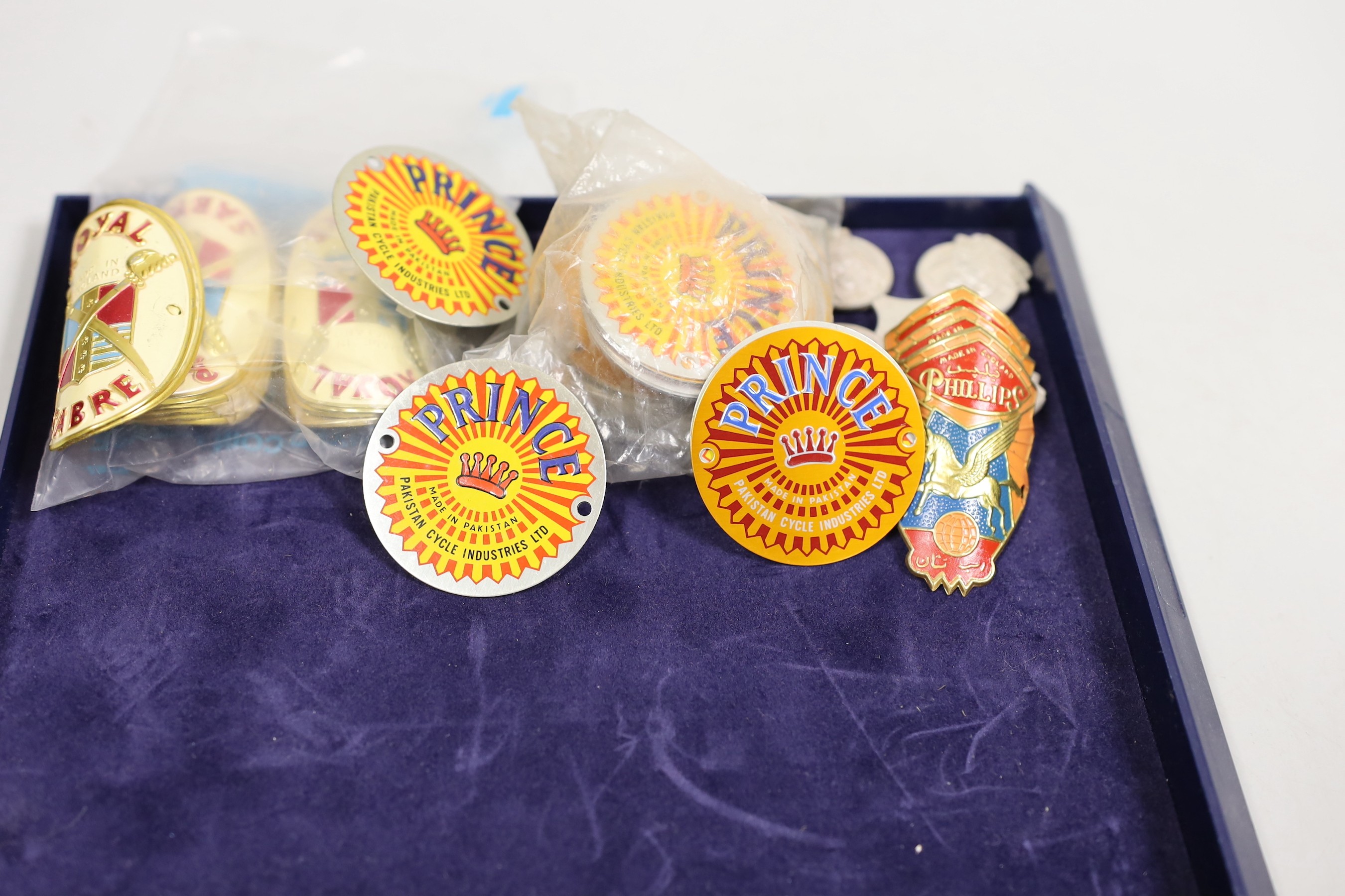 Cycling ephemera - a group of 'new old stock’ vintage bicycle badges, Phillips, Norman, Royal Sabre, Nava Phanick Co etc